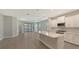 Modern kitchen with white cabinets, quartz countertops, and stainless steel appliances at 26903 Pavin Dr, Englewood, FL 34223