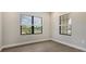 Bright office space with wood-look floors and two large windows at 26903 Pavin Dr, Englewood, FL 34223