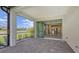 This screened patio boasts sliding doors to the kitchen and views of the backyard at 26903 Pavin Dr, Englewood, FL 34223