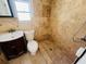 Clean bathroom with a shower/tub combo, toilet, and vanity at 2910 Gulf Dr # B, Holmes Beach, FL 34217