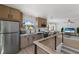 Contemporary kitchen with light wood cabinetry, stainless steel appliances, and an open floor plan at 303 65Th St # B, Holmes Beach, FL 34217
