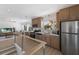 Open concept kitchen with stainless steel appliances and light wood cabinets at 303 65Th St # B, Holmes Beach, FL 34217