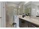 Updated bathroom with frameless shower, granite counters, and modern fixtures at 3115 Trustee Ave, Sarasota, FL 34243