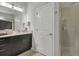 This clean bathroom includes updated cabinets, counters, and a glass door shower at 3115 Trustee Ave, Sarasota, FL 34243