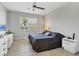 Cozy bedroom featuring a ceiling fan, large window, and neutral tones for a relaxing atmosphere at 3115 Trustee Ave, Sarasota, FL 34243