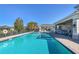 Sparkling community pool with inviting lounge area and outdoor seating, surrounded by lush landscaping at 3115 Trustee Ave, Sarasota, FL 34243