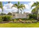 University Village community sign, professionally landscaped and with beautiful blue skies at 3115 Trustee Ave, Sarasota, FL 34243