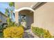 Covered entryway features blue shutters and trim with manicured landscaping at 3115 Trustee Ave, Sarasota, FL 34243