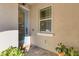 Home's doorway features a glass door, textured walls, and neutral tiling at 3115 Trustee Ave, Sarasota, FL 34243