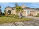 A charming home boasts a two-car garage, pristine landscaping, and a beautifully designed paver driveway at 3115 Trustee Ave, Sarasota, FL 34243
