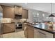 Modern kitchen features stainless steel appliances, stylish cabinets, and a spacious island with seating at 3115 Trustee Ave, Sarasota, FL 34243