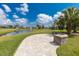Lakeside stone patio offering a tranquil outdoor retreat with pond views at 3115 Trustee Ave, Sarasota, FL 34243