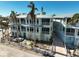 Two-story light teal building with balconies and a courtyard at 318 Bay S Dr # 7, Bradenton Beach, FL 34217