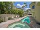 Relaxing resort-style pool and spa with lounge chairs at 318 Bay S Dr # 7, Bradenton Beach, FL 34217