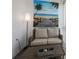 Bright enclosed balcony with wicker furniture and ocean art at 3272 Lake Bayshore Dr # 515, Bradenton, FL 34205