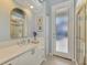 Bathroom with white vanity, quartz countertop, and frosted glass door at 396 Lansbrook Dr, Venice, FL 34292