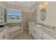 This beautiful bathroom features a soaking tub, walk-in shower, and dual sinks at 396 Lansbrook Dr, Venice, FL 34292