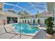 Sparkling screened-in pool with integrated spa and lush landscaping, perfect for relaxation at 396 Lansbrook Dr, Venice, FL 34292