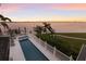 Aerial view of the backyard featuring a long pool, boat dock and waterfront at 4110 Riverview Blvd, Bradenton, FL 34209