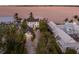 Aerial view of a waterfront estate with multiple buildings, a private dock, and lush, mature landscaping at 4110 Riverview Blvd, Bradenton, FL 34209