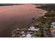 Aerial shot of the waterfront property with a dock and boats surrounded by trees at 4110 Riverview Blvd, Bradenton, FL 34209