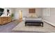Comfortable bedroom with a plush bed, bench, and neutral decor at 4110 Riverview Blvd, Bradenton, FL 34209