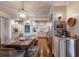 Dining room with wood floors, white trim, a large table with seating, and view into kitchen at 4110 Riverview Blvd, Bradenton, FL 34209