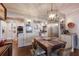 Dining room with wood floors, white trim, a large table with seating, and view into kitchen at 4110 Riverview Blvd, Bradenton, FL 34209