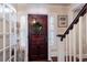 Elegant entryway with a wooden door and white staircase at 4110 Riverview Blvd, Bradenton, FL 34209