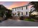 Classic two-story home features black shutters, a portico above the front door, and brick steps leading to the entrance at 4110 Riverview Blvd, Bradenton, FL 34209