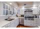Well-lit kitchen showcasing white cabinets, stainless steel appliances, and a subway tile backsplash at 4110 Riverview Blvd, Bradenton, FL 34209