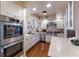 Bright kitchen featuring white cabinets, stainless steel appliances, and a double oven at 4110 Riverview Blvd, Bradenton, FL 34209