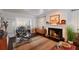 Cozy living room featuring a fireplace, mid-century furniture, and views to an outdoor seating area at 4110 Riverview Blvd, Bradenton, FL 34209