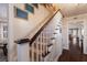 Classic wooden staircase with white railings and wall art at 4110 Riverview Blvd, Bradenton, FL 34209