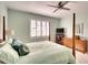 Spacious bedroom with a post bed, dresser, and large window with shutters at 415 Fairway Isles Ln, Bradenton, FL 34212