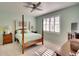 Spacious bedroom with wood post bed and plenty of sunlight at 415 Fairway Isles Ln, Bradenton, FL 34212