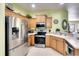 Modern kitchen with stainless steel appliances and wood cabinets at 415 Fairway Isles Ln, Bradenton, FL 34212