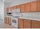 White appliances and light wood cabinets in a bright kitchen at 4181 Lenox Blvd, Venice, FL 34293