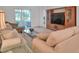 Bright living room with comfy sofas, a large TV, and access to a relaxing patio at 4181 Lenox Blvd, Venice, FL 34293