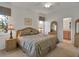 Main bedroom with a king-size bed, ensuite bathroom access, and ample closet space at 4181 Lenox Blvd, Venice, FL 34293