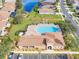 Community pool with lounge chairs and adjacent clubhouse at 4181 Lenox Blvd, Venice, FL 34293