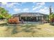 Home's backyard with a screened pool and lush landscaping at 4239 Durant St, Port Charlotte, FL 33948