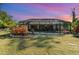 Backyard view of home at sunset, showcasing the screened pool at 4239 Durant St, Port Charlotte, FL 33948