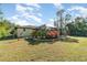 Landscaped backyard featuring a screened pool area at 4239 Durant St, Port Charlotte, FL 33948