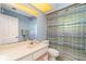 Clean bathroom with shower/tub combo, vanity, and striped shower curtain at 4239 Durant St, Port Charlotte, FL 33948