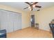 Spacious bedroom with wood floors, double doors to closet, and access to bathroom at 4239 Durant St, Port Charlotte, FL 33948
