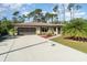 Single-story home with a two-car garage and landscaped front yard at 4239 Durant St, Port Charlotte, FL 33948