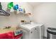 Laundry room with washer, dryer, utility sink, and shelving at 4239 Durant St, Port Charlotte, FL 33948