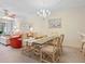 Dining area with glass-top table, chandelier, and seating for six at 4495 Longmeadow # 77, Sarasota, FL 34235