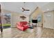 Living room with red couches, a large TV, and high ceilings at 4564 Iola Dr, Sarasota, FL 34231